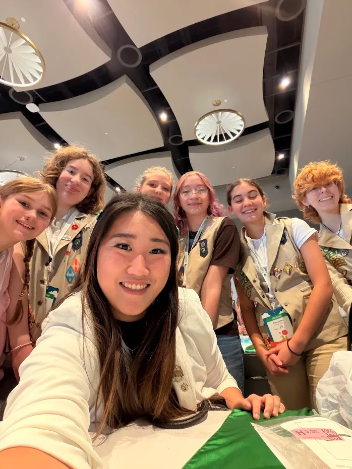 Selfie with a group of Girl Scouts in uniform, smiling